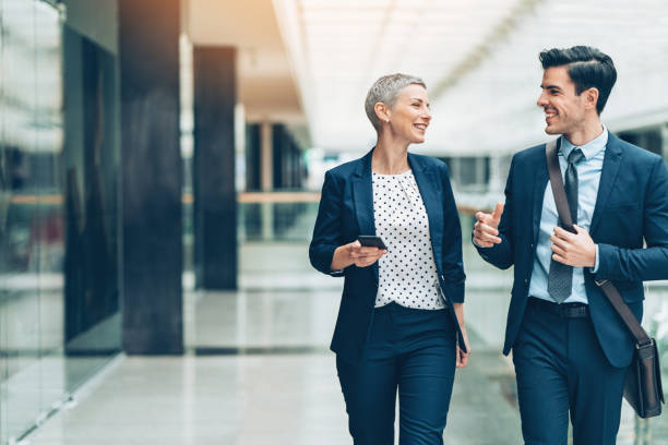 Two businesspersons walking together and talking